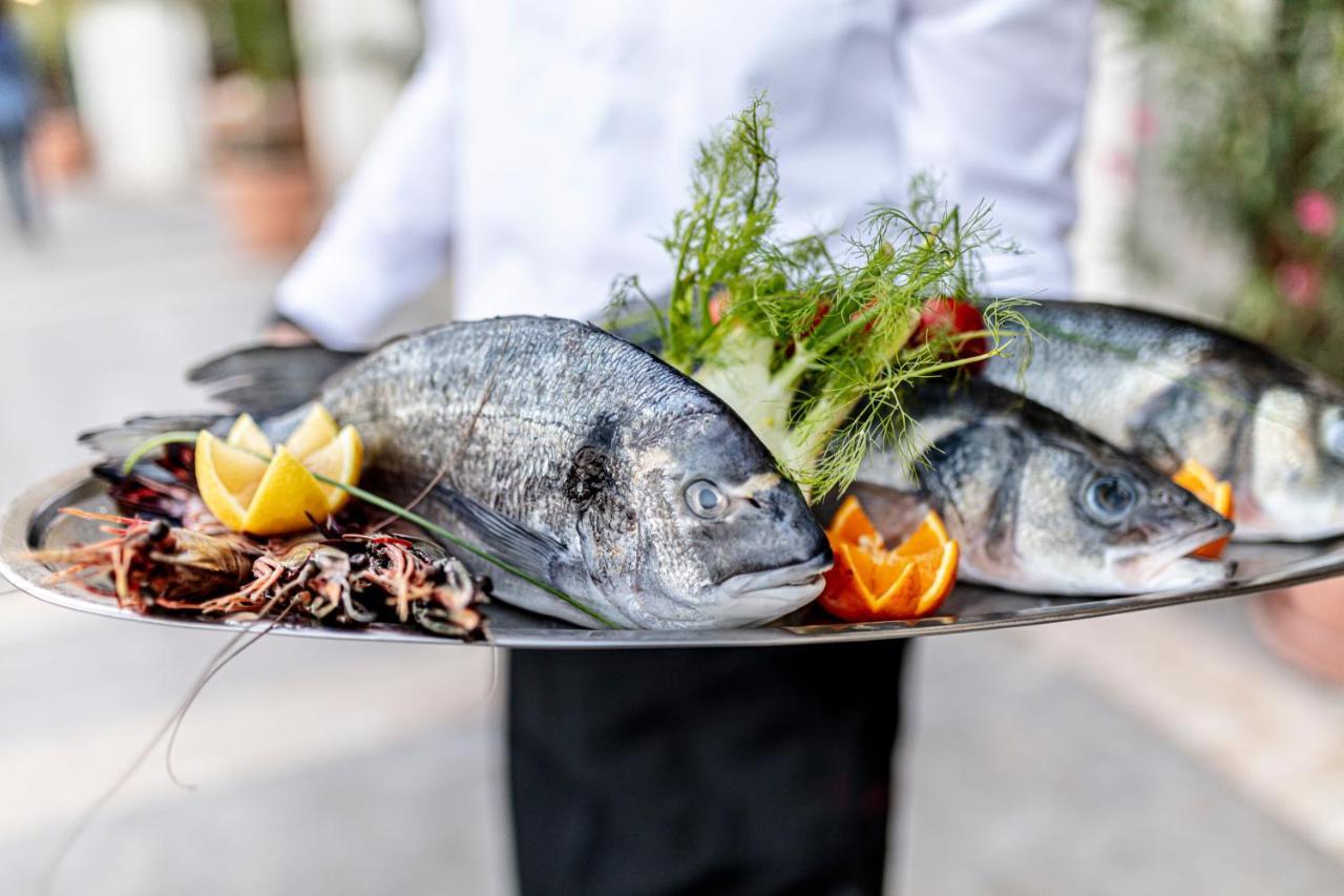 Lighthouse Golf & Spa Hotel Baltsjik Eksteriør bilde A waiter holding a platter of fish